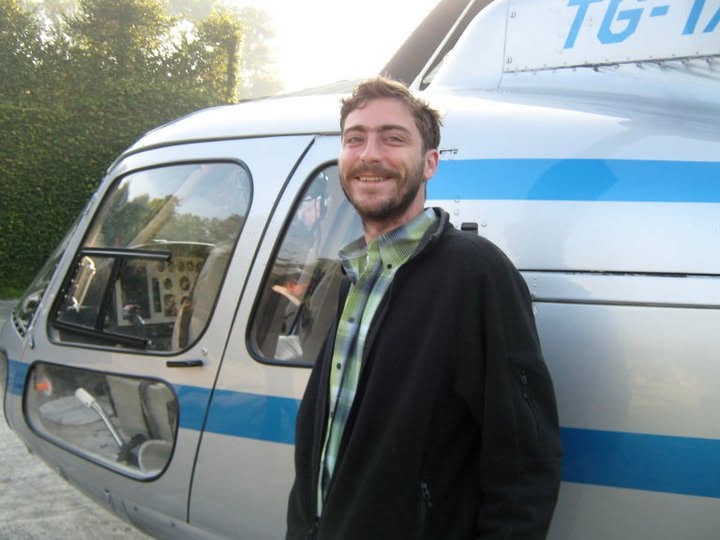 Eric standing beside a helicopter