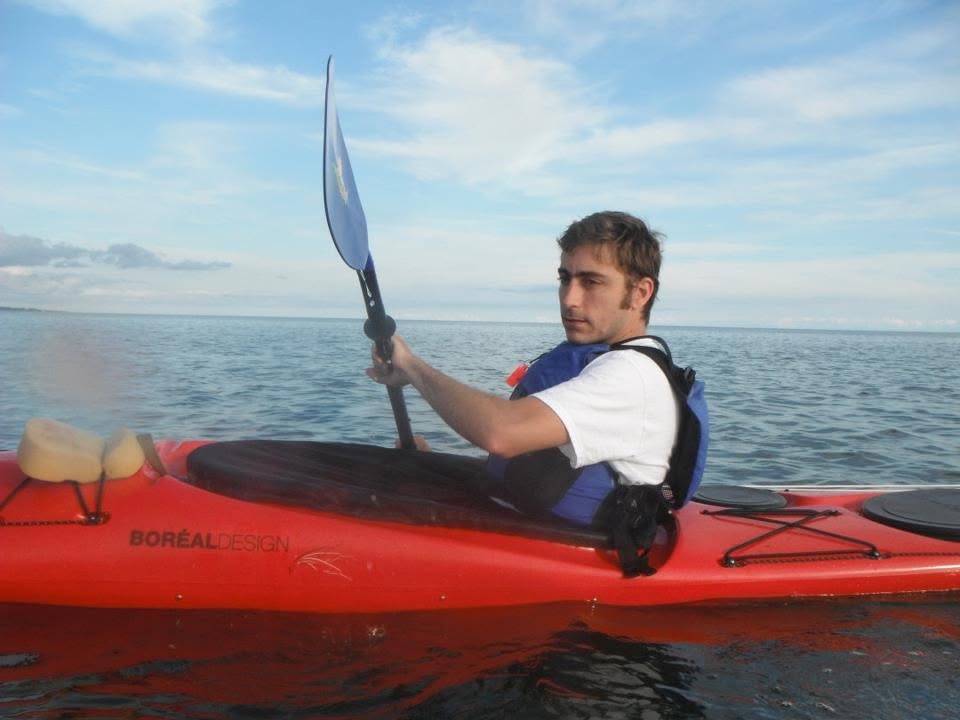 Eric paddling a red kayak